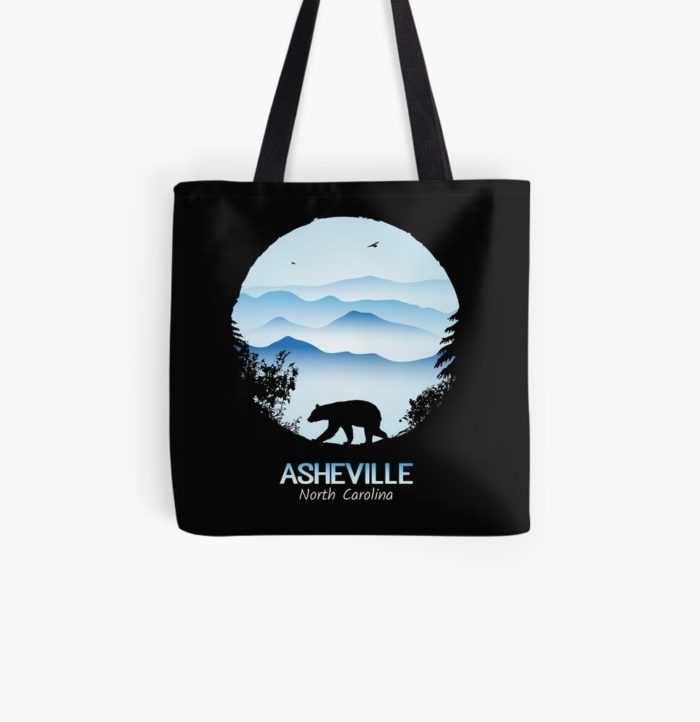 Asheville souvenir design with black bear and tree silhouette against the Blue Ridge Mountains of North Carolina.