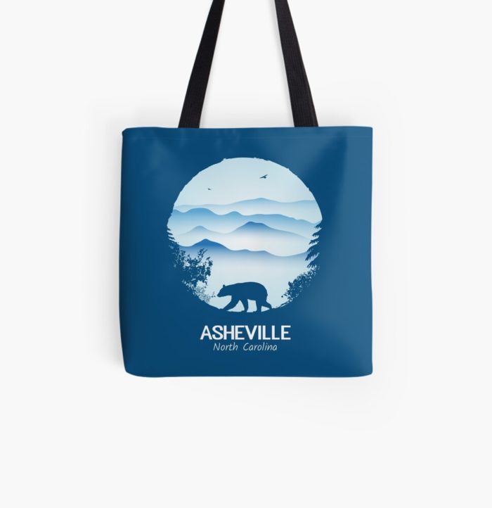 Asheville souvenir merchandise design with black bear and tree silhouette against the Blue Ridge Mountains of North Carolina.