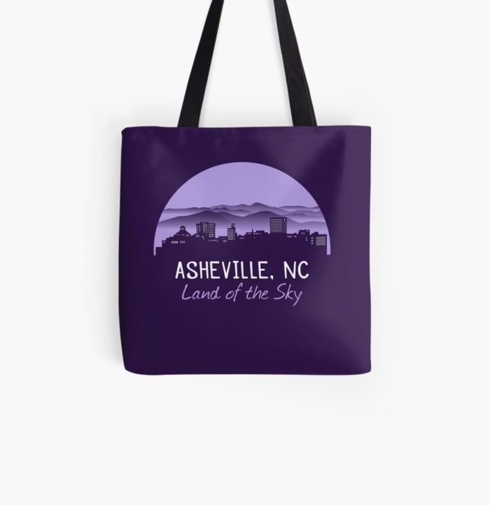 Asheville, North Carolina merchandise design with a cityscape against the Blue Ridge Mountains and Asheville's famous nickname"Land of the Sky."